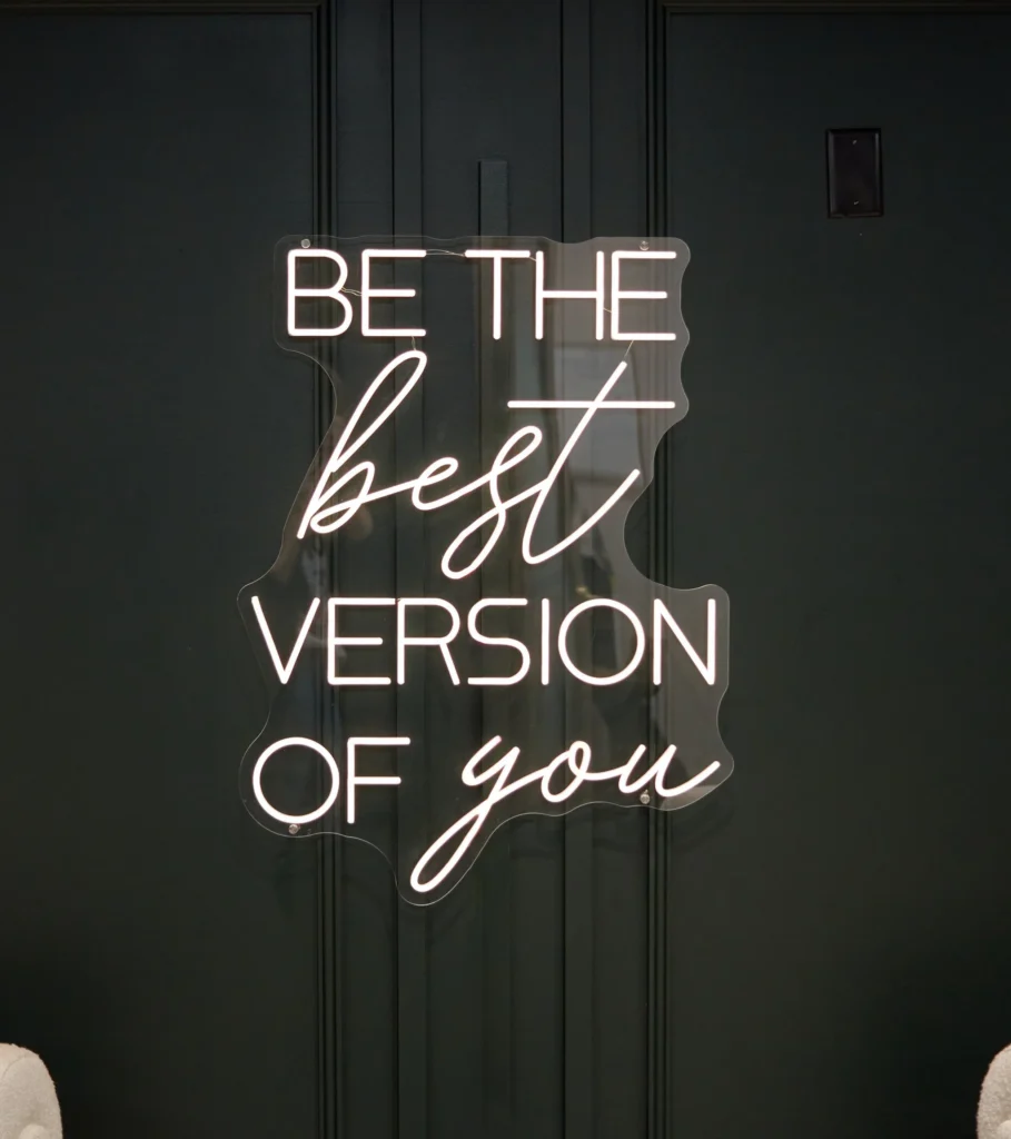 Neon sign reading be the best version of you at the symm label in Calgary