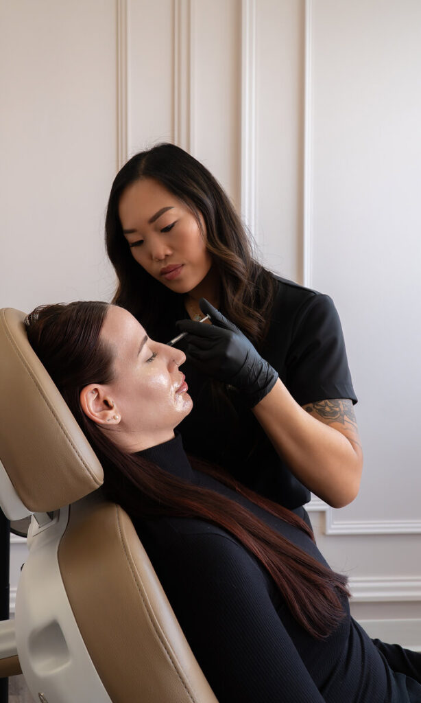 woman receiving facial balancing cheek injection at the symm label in calgary