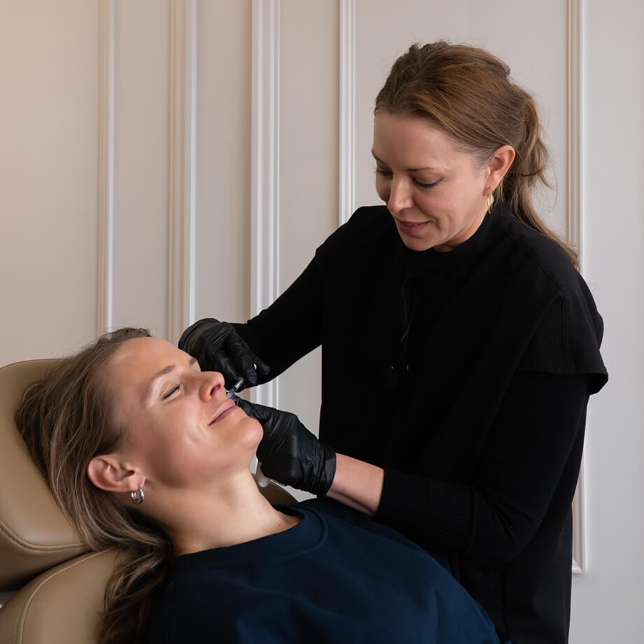Woman receiving cheek injection at The Symm Label in Calgary