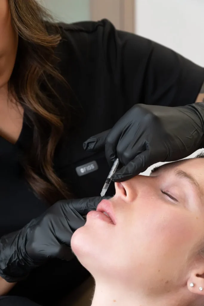 patient receiving lip filler injection at the symm label in Calgary